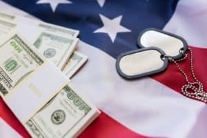 guard drill pay explained military forces, recruitment, financing and national service concept - close up of american flag, dollar money and military badges